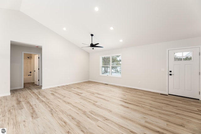 unfurnished living room featuring light wood-type flooring, vaulted ceiling, and ceiling fan