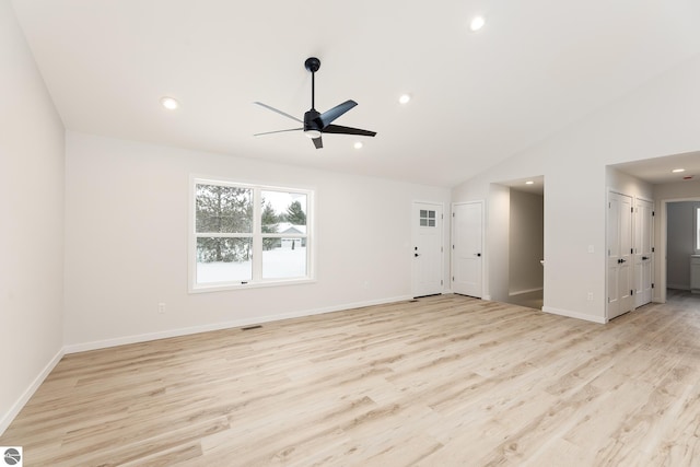 unfurnished living room with light hardwood / wood-style floors, ceiling fan, and vaulted ceiling