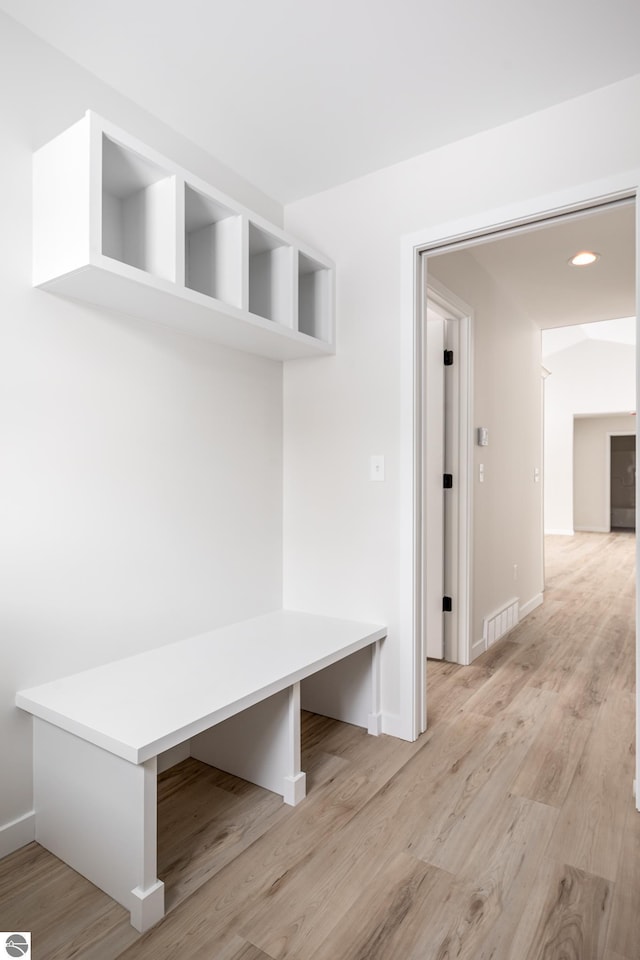 mudroom with light hardwood / wood-style floors