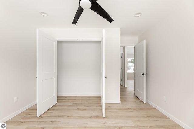 unfurnished bedroom featuring light hardwood / wood-style flooring, a closet, and ceiling fan