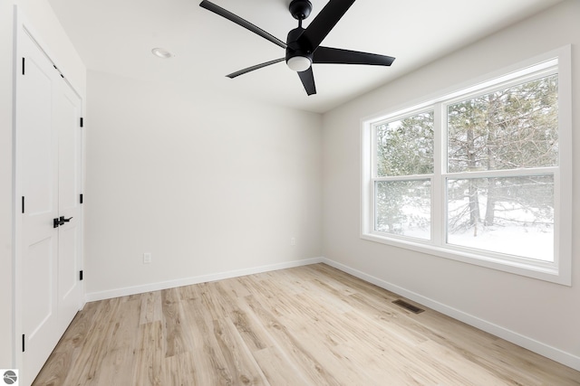 spare room with ceiling fan and light hardwood / wood-style flooring