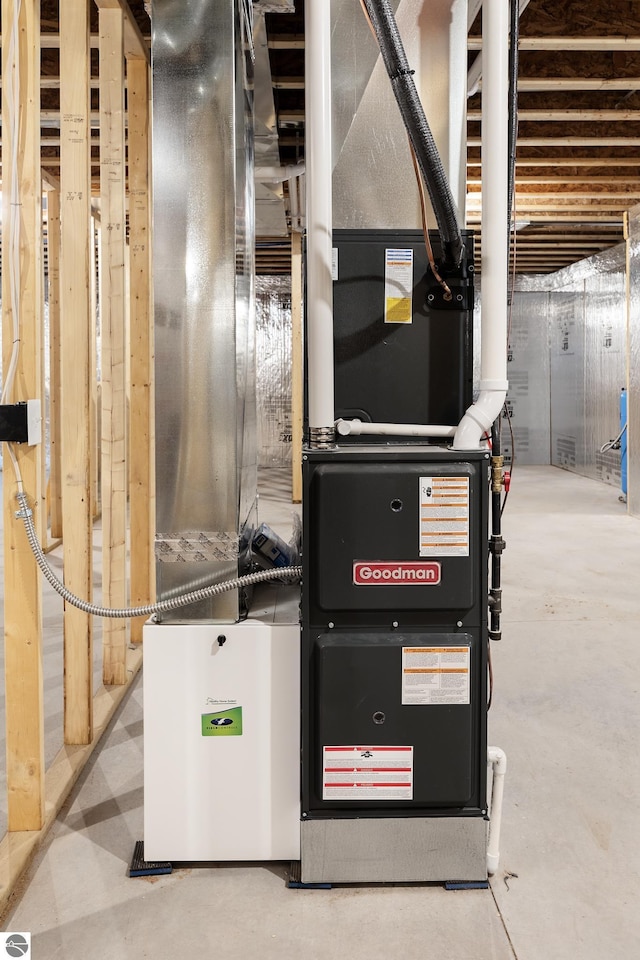 utility room featuring heating unit