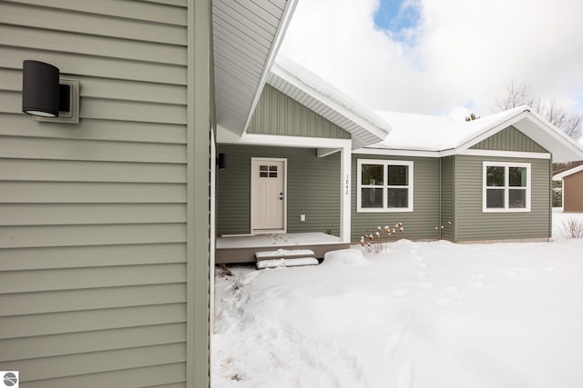 view of snow covered property entrance