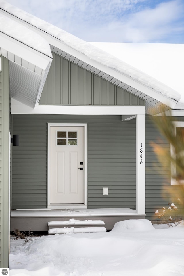 view of snow covered property entrance