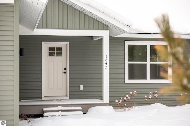 view of snow covered property entrance