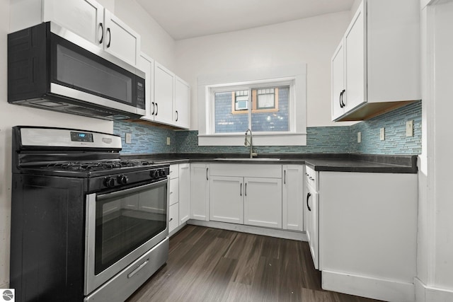 kitchen featuring sink, white cabinets, appliances with stainless steel finishes, and dark hardwood / wood-style floors