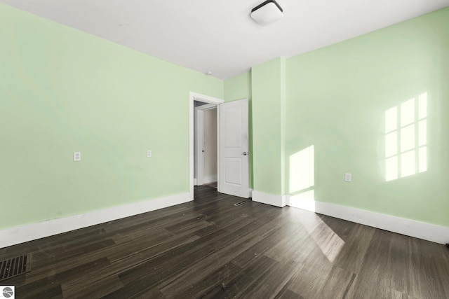 empty room featuring dark hardwood / wood-style flooring