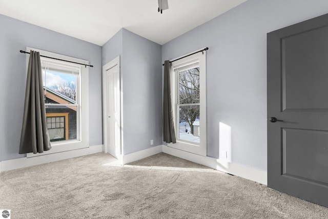 carpeted spare room with plenty of natural light