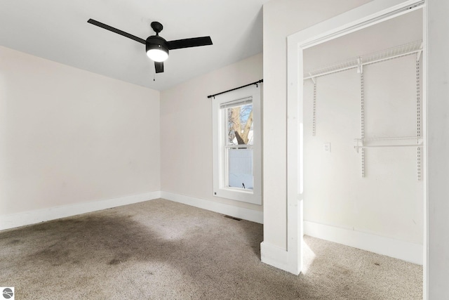 unfurnished bedroom with ceiling fan, carpet, and a closet