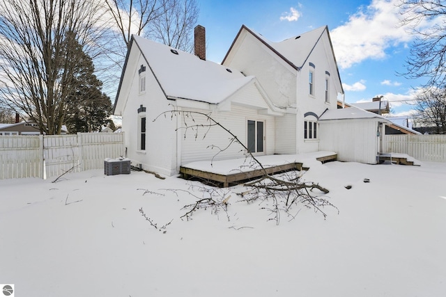 view of snow covered rear of property