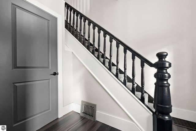 stairs with hardwood / wood-style floors