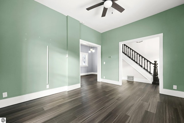 spare room with dark wood-type flooring and ceiling fan