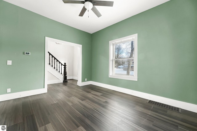 unfurnished room with ceiling fan and dark hardwood / wood-style flooring