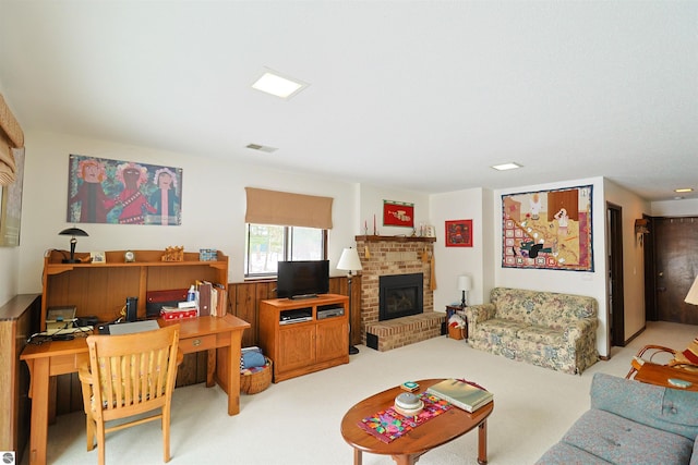 living room featuring a brick fireplace, wooden walls, and light carpet