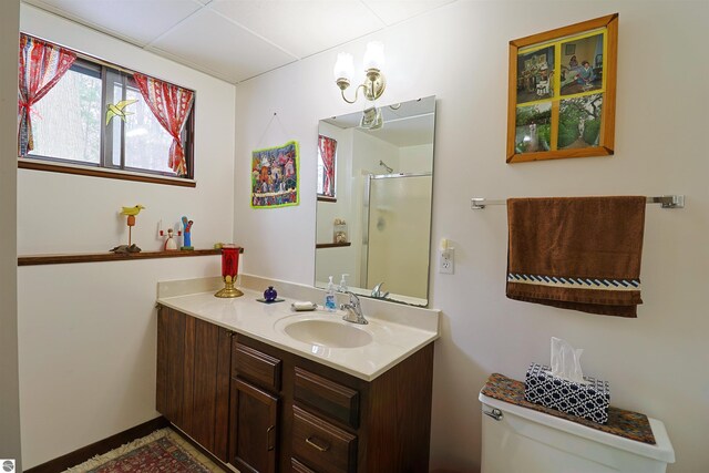 bathroom with a shower with door, toilet, and vanity