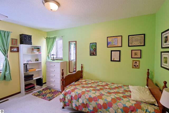 carpeted bedroom with a textured ceiling