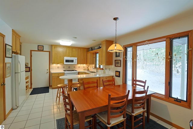 dining area with sink and light tile patterned flooring