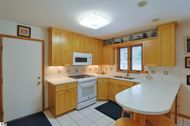 kitchen featuring kitchen peninsula, light brown cabinets, sink, backsplash, and white appliances