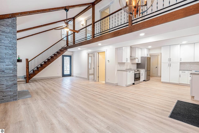 unfurnished living room with light wood-type flooring, beamed ceiling, and high vaulted ceiling