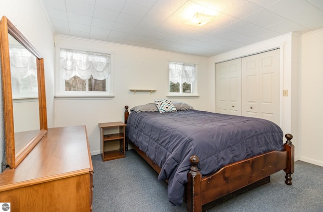 bedroom with a closet, carpet, and crown molding