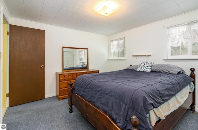 carpeted bedroom with ornamental molding