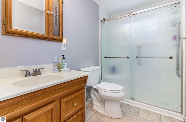 bathroom with vanity, toilet, and a shower with door