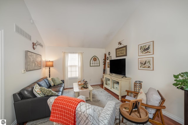 living room with vaulted ceiling and wood-type flooring