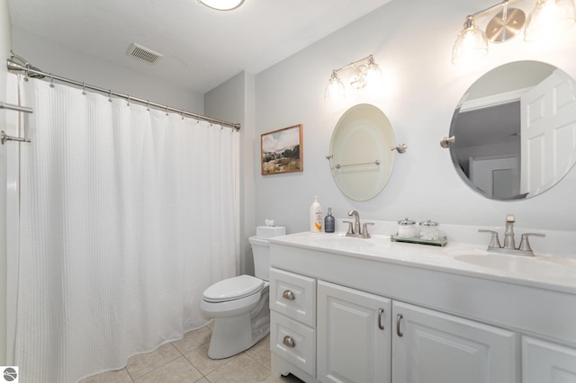 bathroom with tile patterned floors, vanity, and toilet