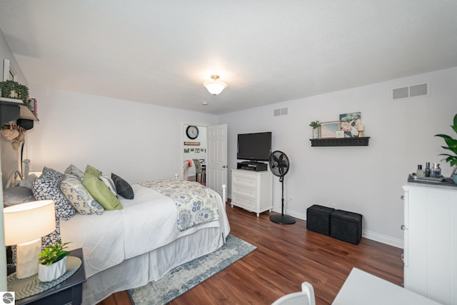 bedroom with dark hardwood / wood-style flooring