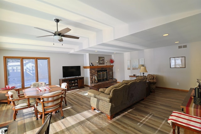 living room with a brick fireplace, hardwood / wood-style floors, and ceiling fan