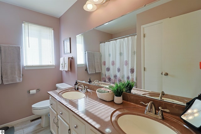 bathroom with toilet and vanity