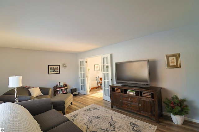 living room featuring light wood-type flooring and french doors