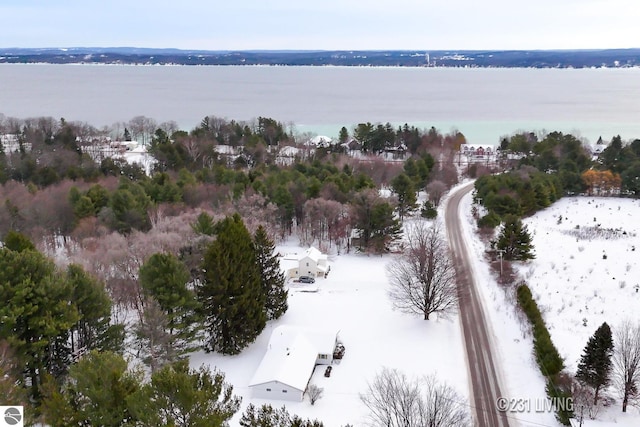 snowy aerial view featuring a water view