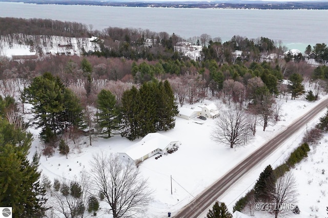 snowy aerial view featuring a water view