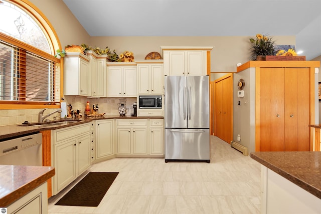 kitchen featuring cream cabinets, built in microwave, dishwasher, stainless steel refrigerator, and baseboard heating