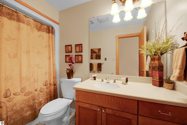 bathroom featuring toilet, tile patterned flooring, and vanity