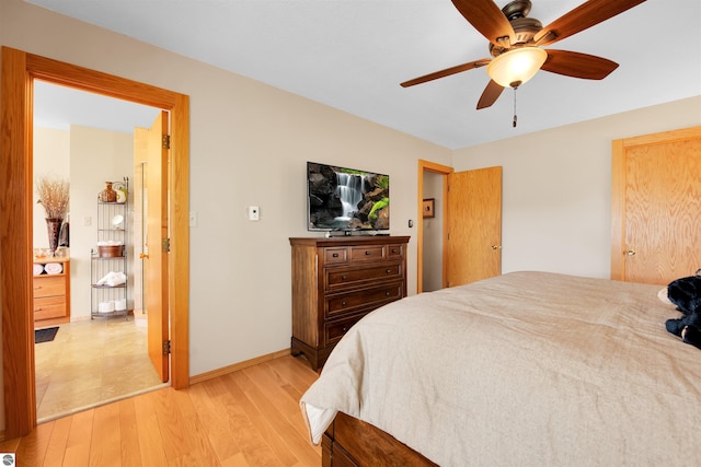 bedroom with light wood-type flooring and ceiling fan