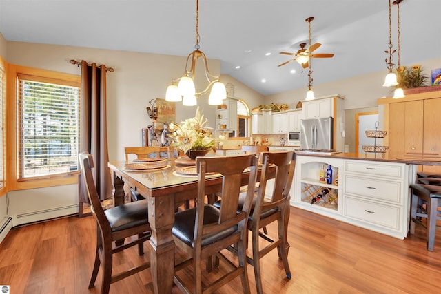 dining space with light wood-type flooring, ceiling fan with notable chandelier, and lofted ceiling