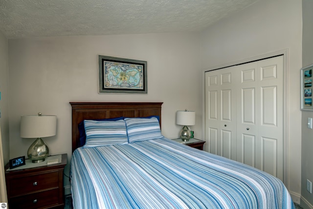 bedroom featuring vaulted ceiling, a closet, and a textured ceiling