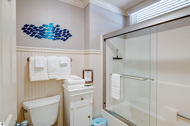 bathroom featuring bath / shower combo with glass door and toilet