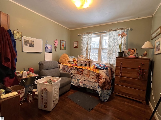 bedroom with crown molding and dark hardwood / wood-style floors