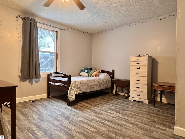 bedroom featuring hardwood / wood-style floors, a textured ceiling, and ceiling fan