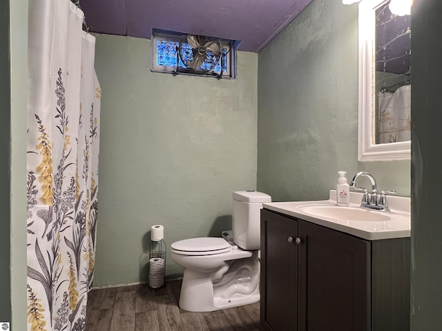 bathroom with vanity, toilet, and hardwood / wood-style floors