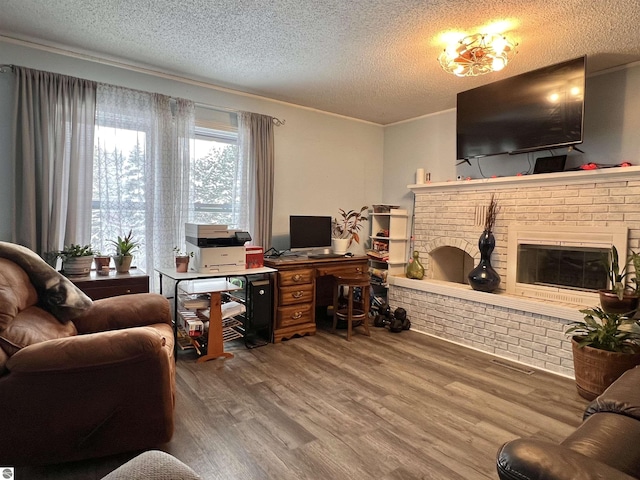 office area with a fireplace, hardwood / wood-style floors, and a textured ceiling