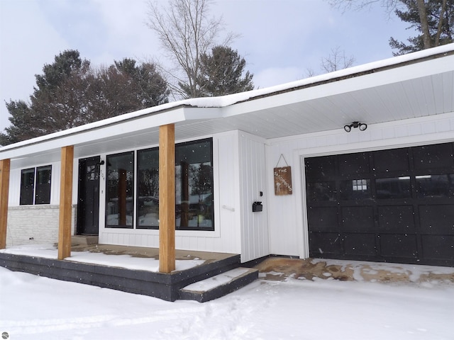 view of snow covered property entrance