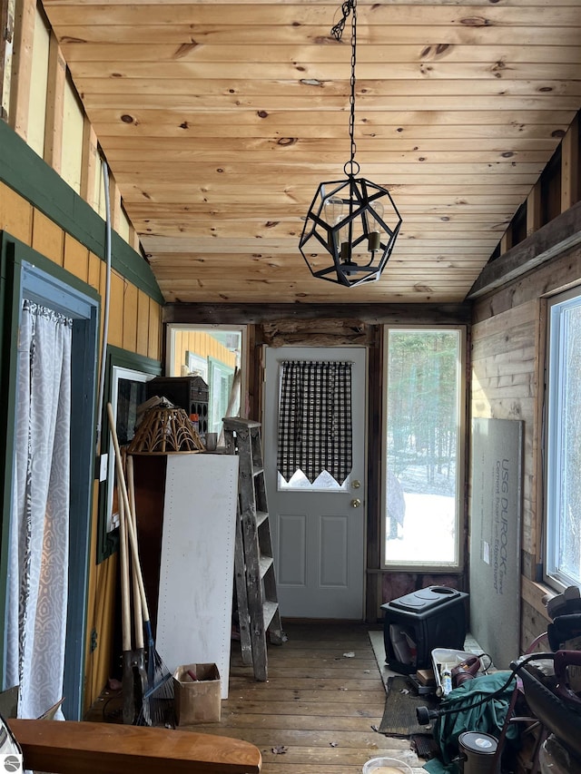 entrance foyer featuring lofted ceiling, hardwood / wood-style floors, wooden ceiling, and wood walls