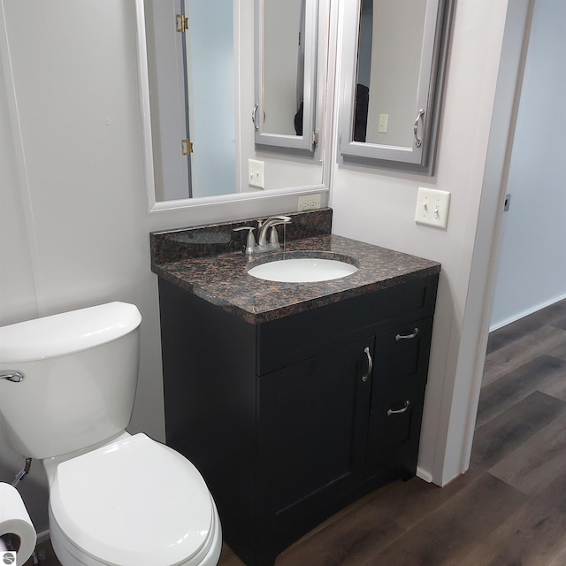 bathroom with vanity, hardwood / wood-style flooring, and toilet