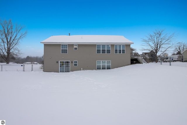 snow covered property featuring a deck