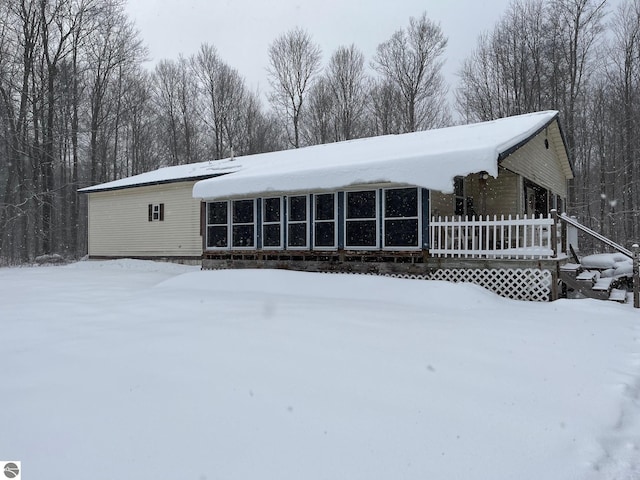 view of snow covered rear of property