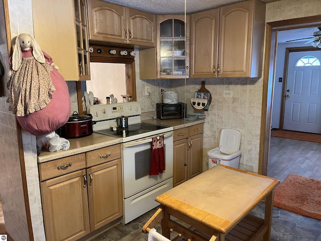 kitchen with tasteful backsplash, ceiling fan, and white electric stove